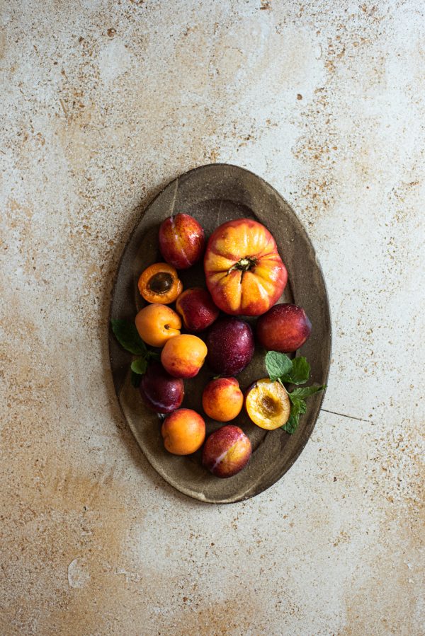 ceramic platter green elephant and fruits and vegetables on a background of mbackdrops